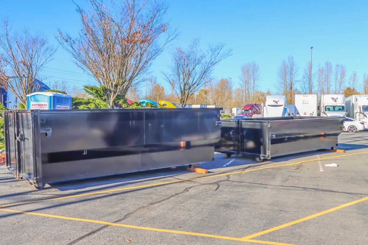 Professional dumpster rental service with roll-off container on residential driveway in Beardstown